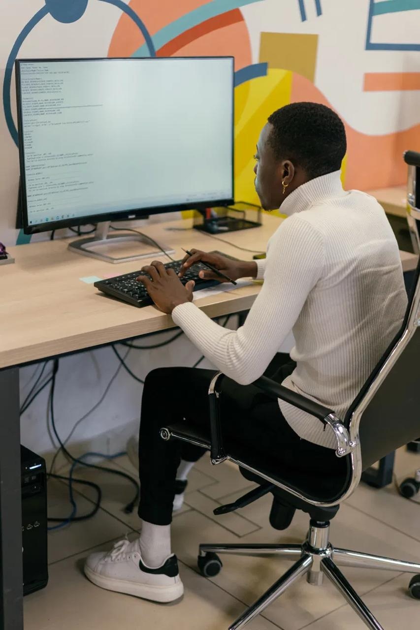 Figure Academy team members reviewing work on a laptop